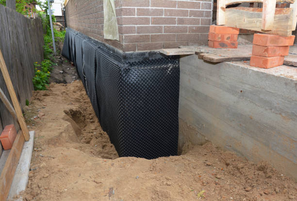Happy homeowners after waterproofing job in Toledo